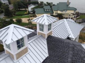 Roofer installing Standing Seam and Shingles